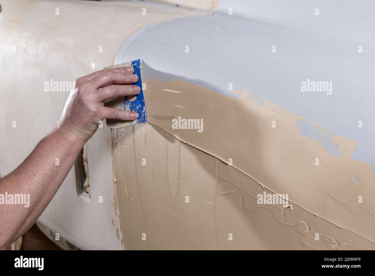 Close-up of using two-component adhesive at a car Stock Photo