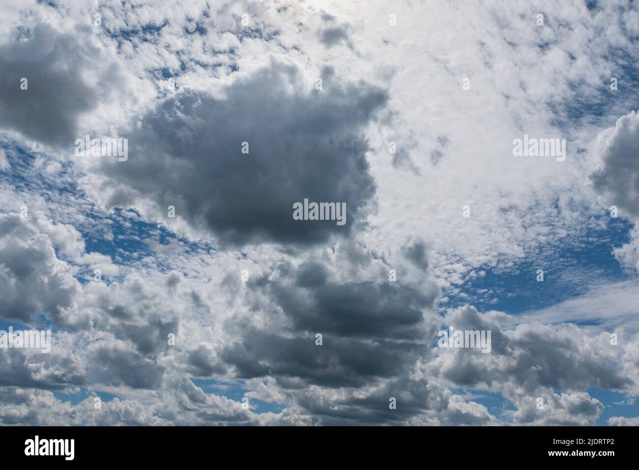 Blue sky with different types of clouds at different altitudes Stock Photo