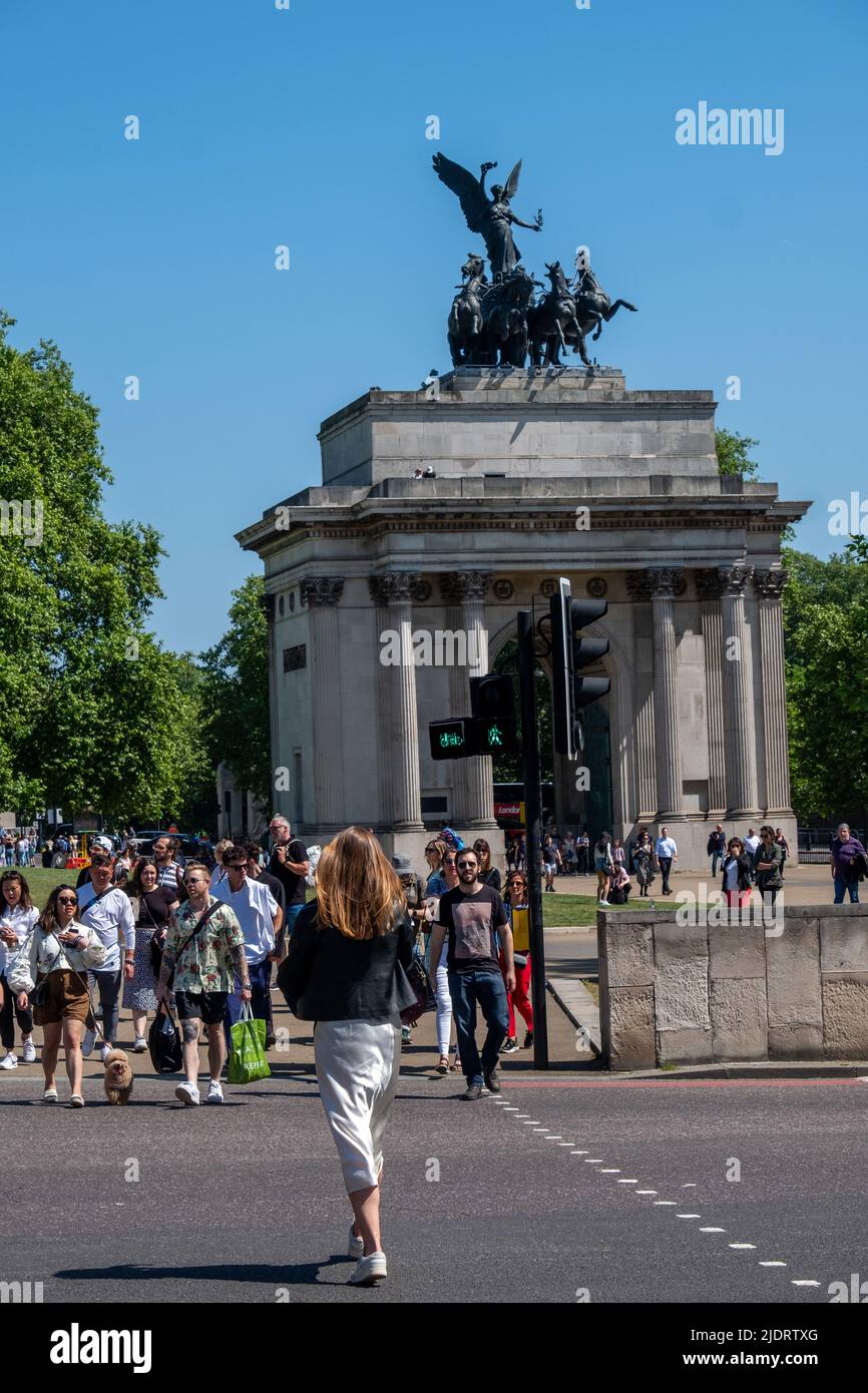 London- May 2022: Wellington Arch and crowds of people on bright summers day in London Stock Photo