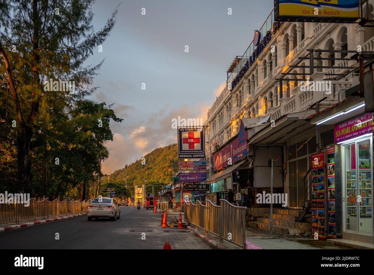 Thawewong Road in Patong at sunset during covid-19 pandemic. Normally this road along Patong beach is very busy day and night. Stock Photo