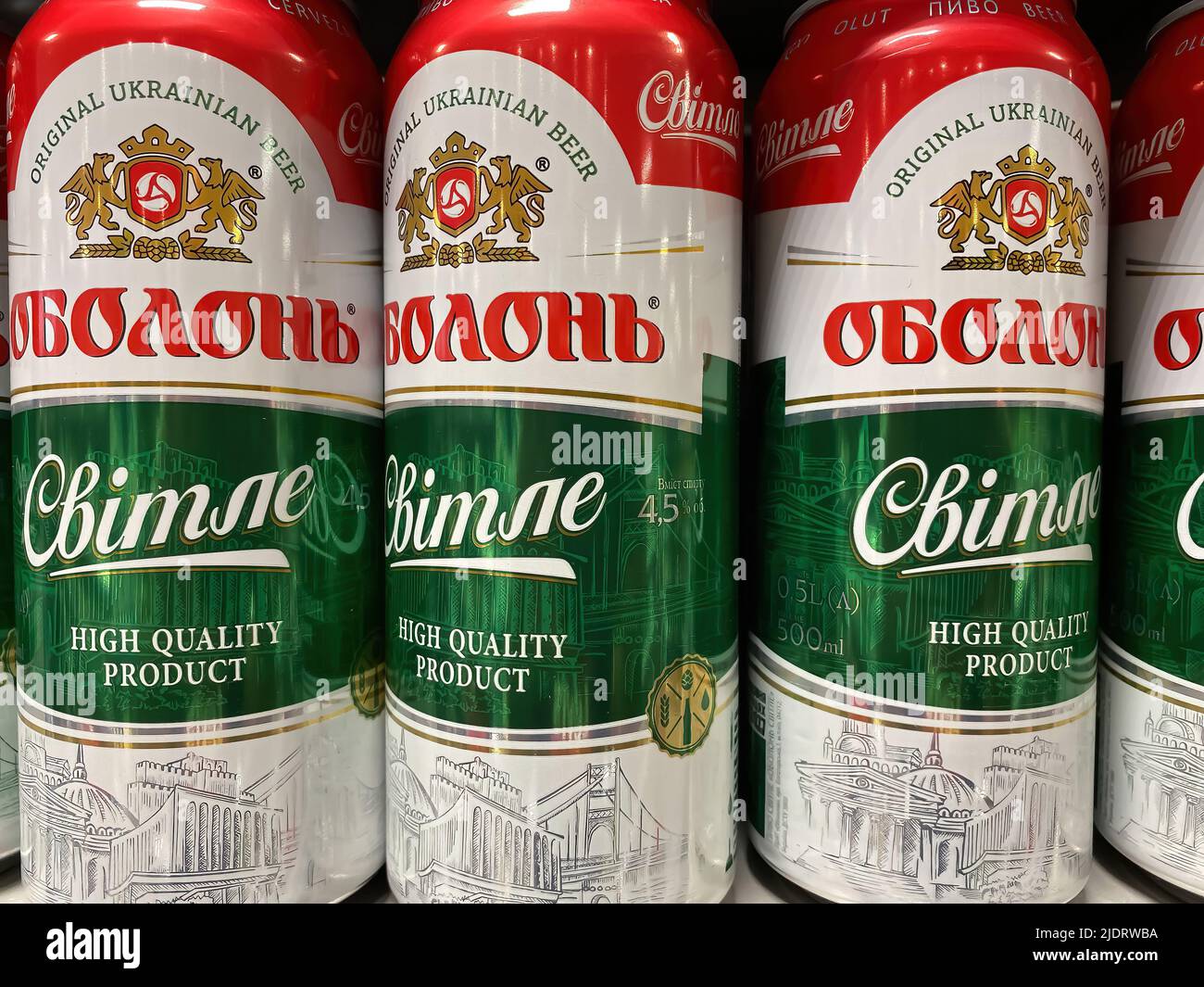 Erkelenz, Germany - June 9. 2022: Closeup of beer cans ukrainian Obolon light beer in shelf of german supermarket (focus on center of central can) Stock Photo