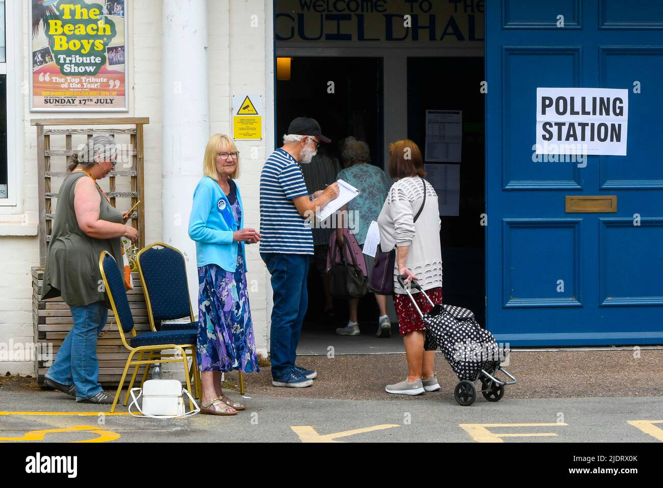 Axminster, Devon, UK.  23rd June 2022.  Voters enter a polling station at the Guild Hall at Axminster in Devon to cast their vote for the parliamentary election for the Tiverton and Honiton constituency.  Picture Credit: Graham Hunt/Alamy Live News Stock Photo