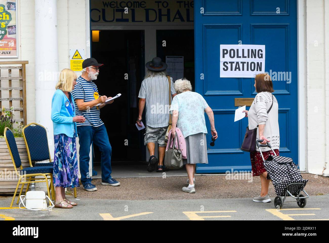 Axminster, Devon, UK.  23rd June 2022.  Voters enter a polling station at the Guild Hall at Axminster in Devon to cast their vote for the parliamentary election for the Tiverton and Honiton constituency.  Picture Credit: Graham Hunt/Alamy Live News Stock Photo