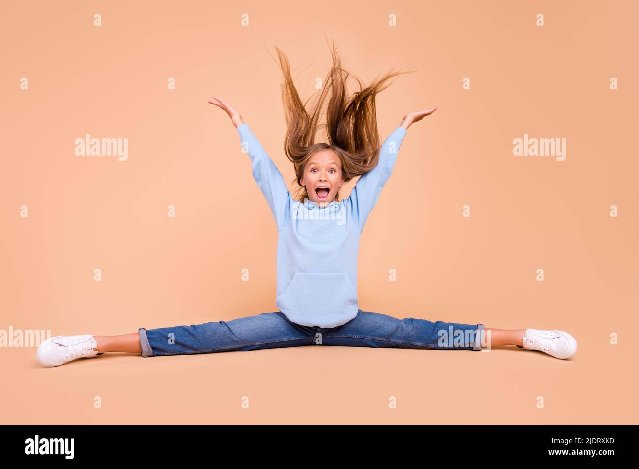 Full size portrait of overjoyed positive person sit floor split legs ...