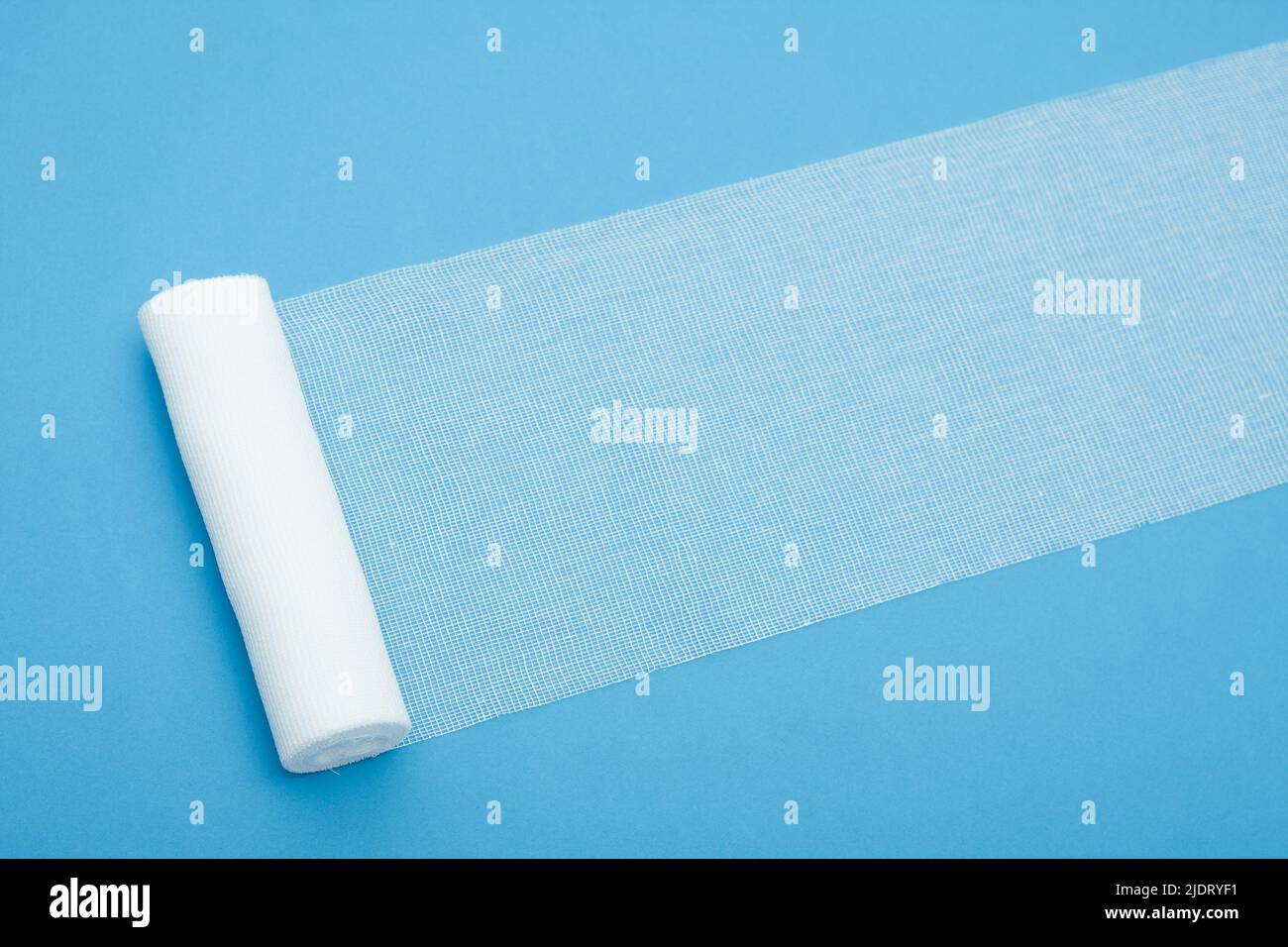 Medical sterile bandage on blue background Stock Photo Alamy