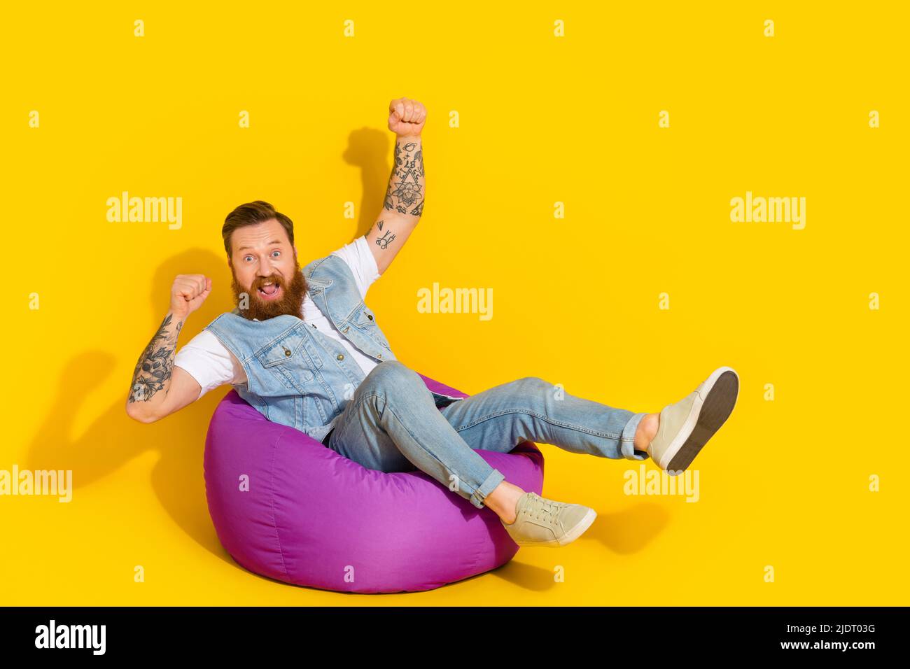 Photo of lucky charming guy dressed denim vest having rest bean bag