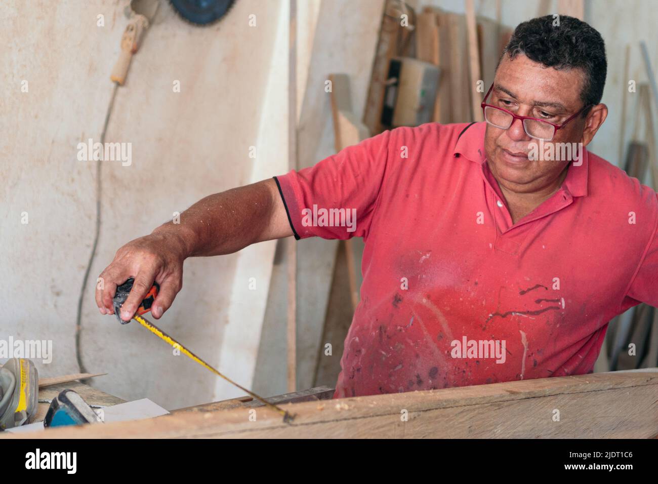 Elderly carpenter working at his workshop. Stock Photo