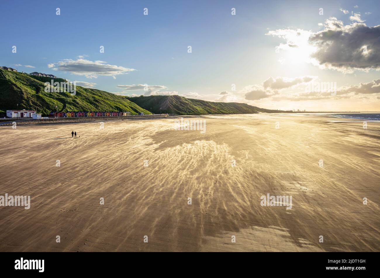 Saltburn by the sea Saltburn beach with blowing sand and two people saltburn by the sea North Yorkshire Redcar and Cleveland England uk gb Europe Stock Photo