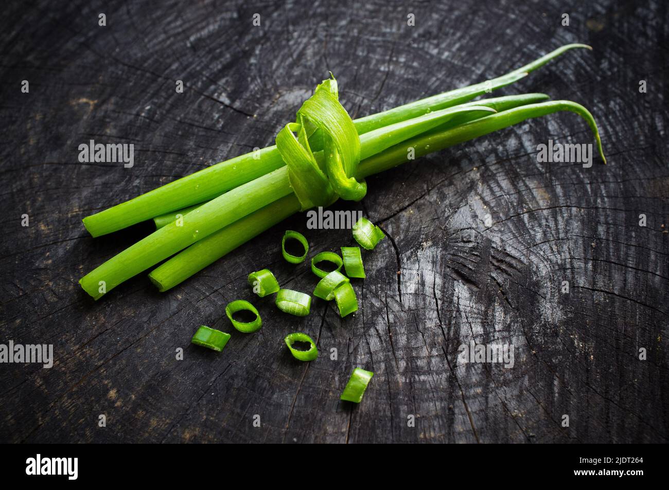 bunch of green onions on the dark background Stock Photo - Alamy