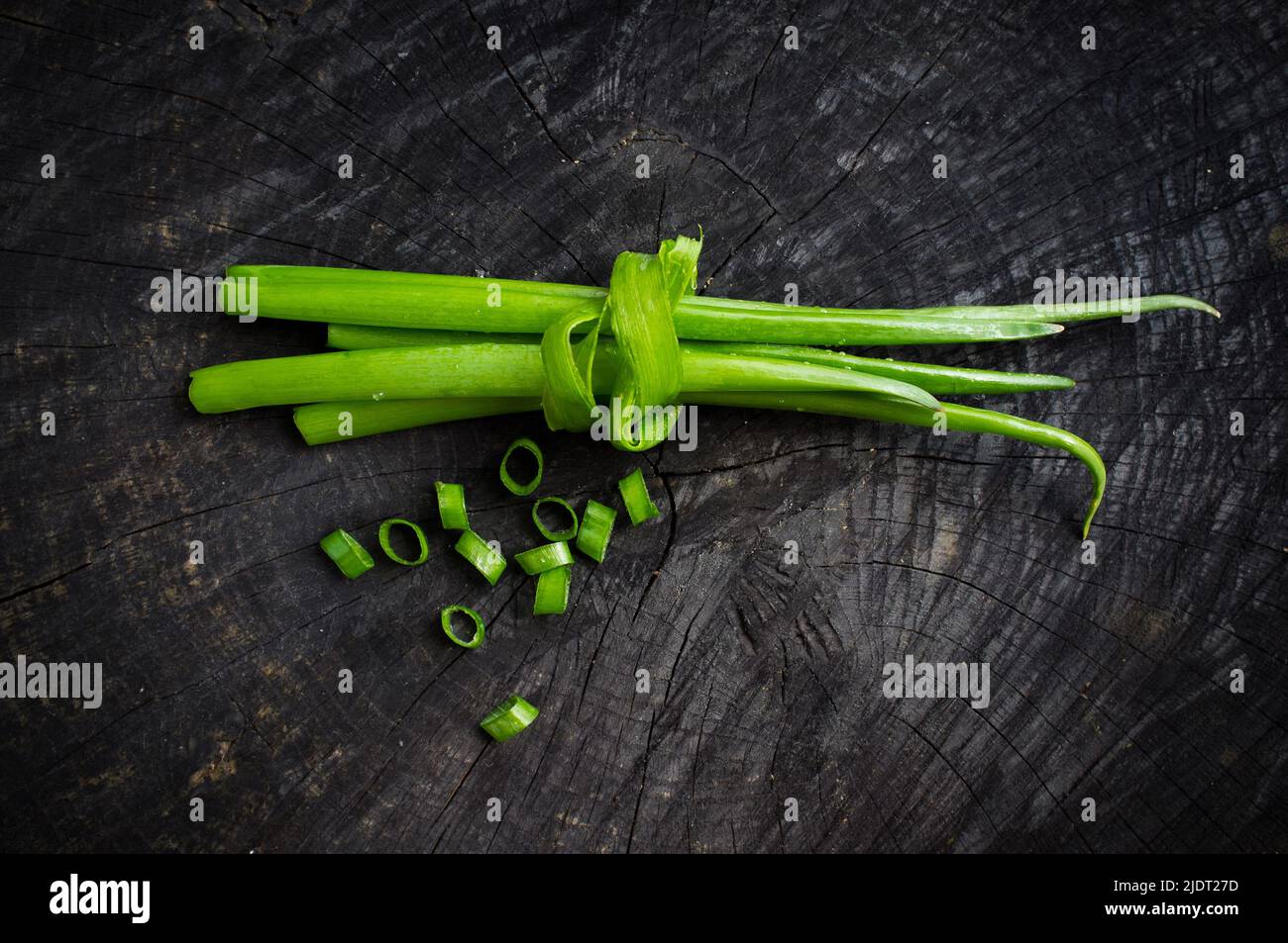 bunch of green onions on the dark background Stock Photo - Alamy