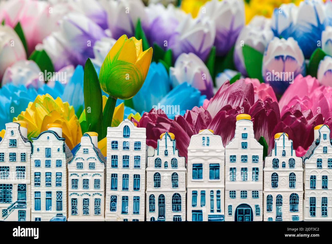 Colorful wooden tulips with small souvenir Amsterdam canal houses in front Stock Photo