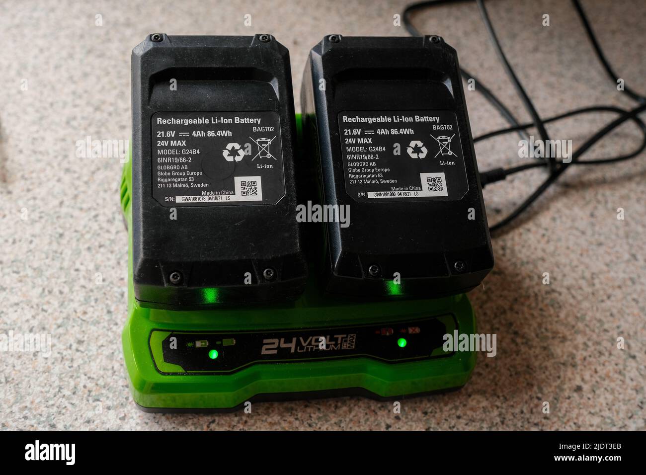 Two 24V Li-Ion Lawnmower batteries on charge. Stock Photo