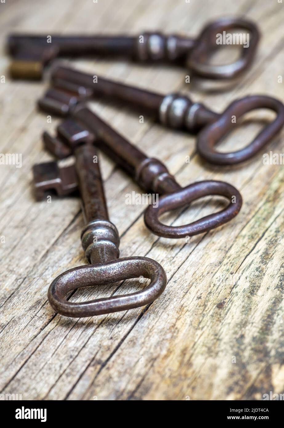 Old vintage iron keys on a wooden background. Escape room game, access ...