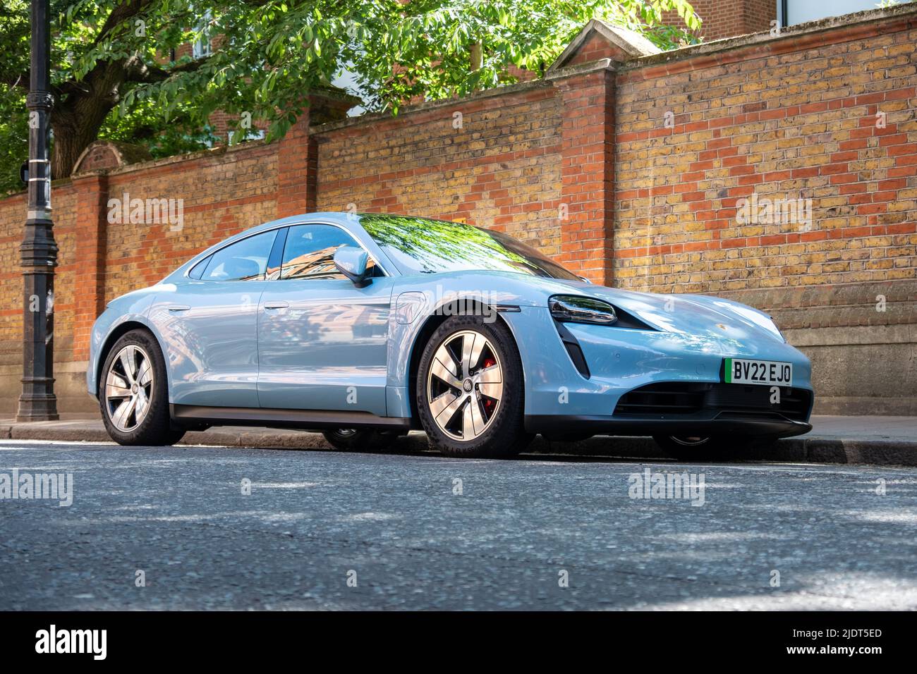 London- May 2022: Porsche Taycan 4S electric car parked on bright London street Stock Photo