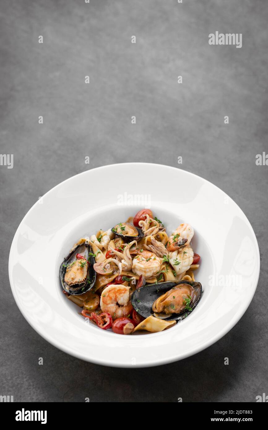 Frutti Di Mare fresh mixed seafood tagliatelle with mussels, prawns and shrimp Stock Photo