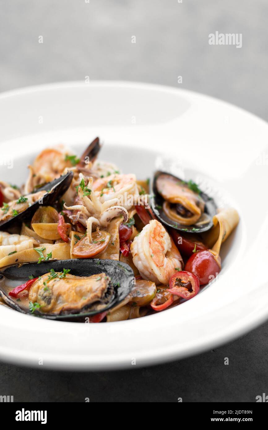 Frutti Di Mare fresh mixed seafood tagliatelle with mussels, prawns and shrimp Stock Photo