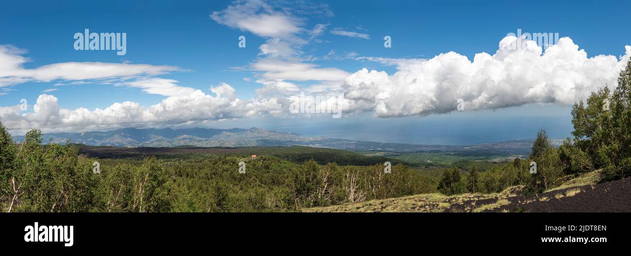 A panoramic view from Mount Etna, Sicily, Italy, looking NE over the mountain hut of Rifugio Citelli towards Taormina and the Nebrodi Mountains Stock Photo