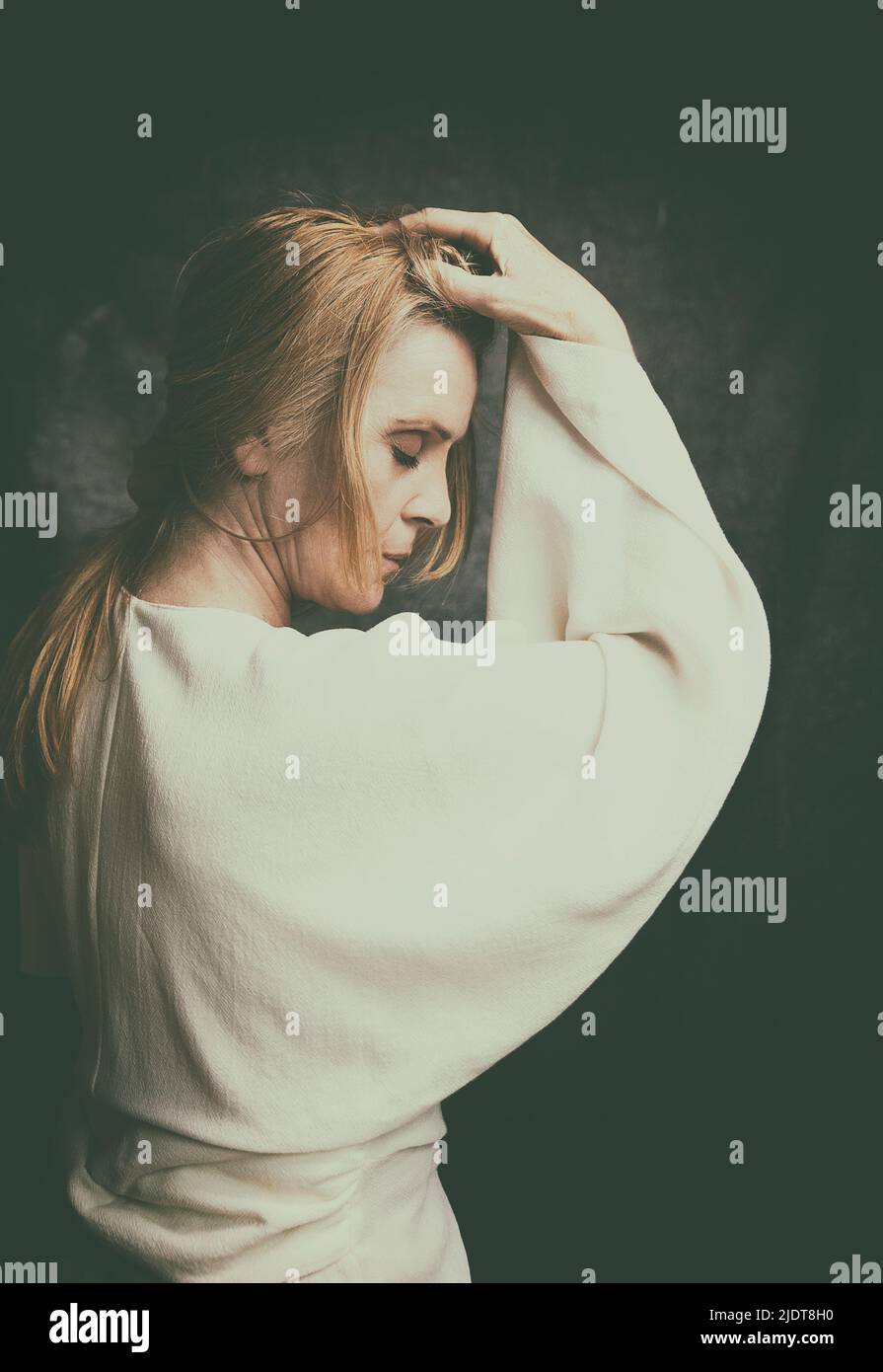 portrait of blonde woman in white blouse VI Stock Photo