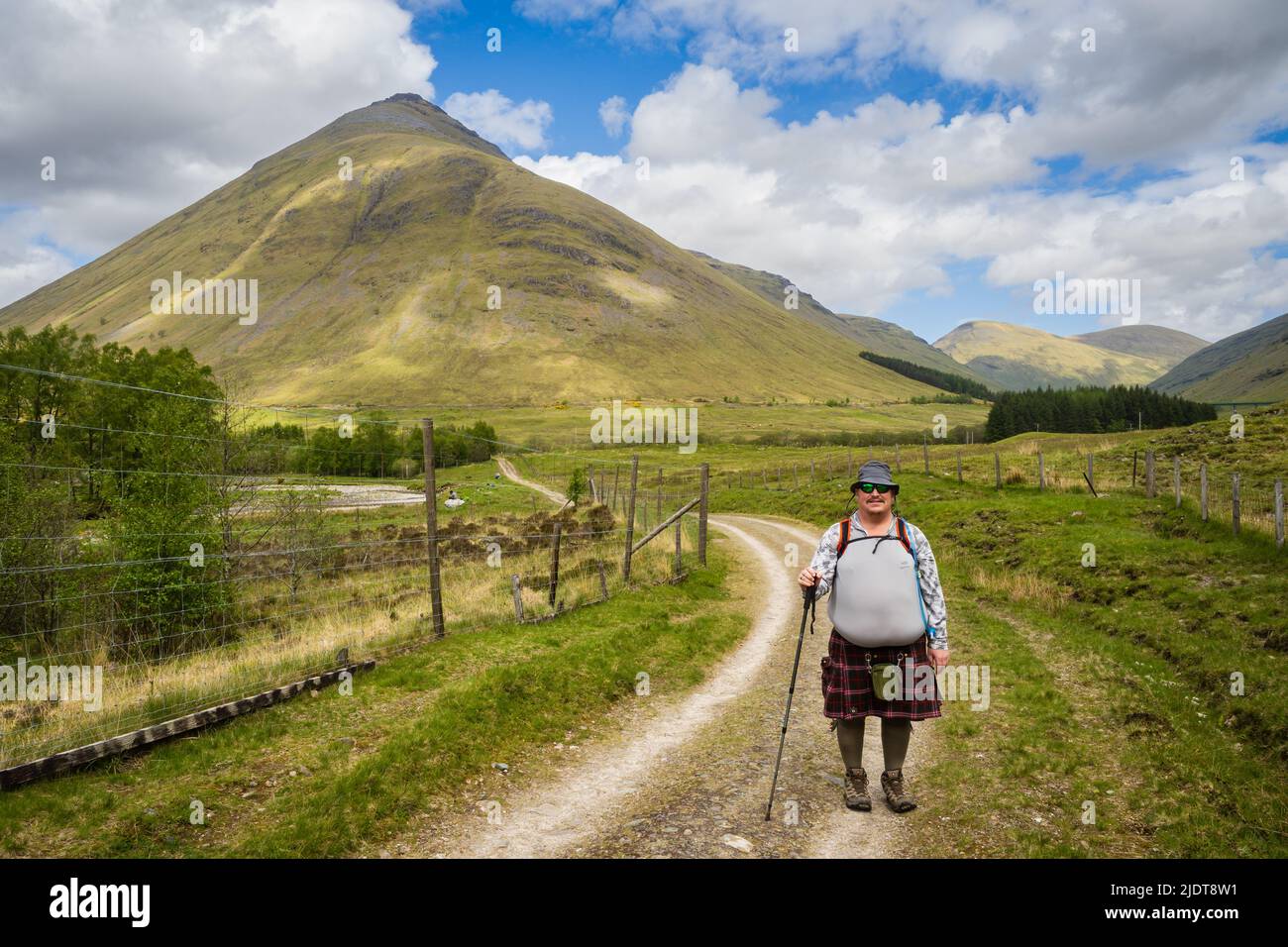 19.05.2022 Tyndrum, Argyll, Scotland, UK. Walker wearing a kilt on the West Highland Way is a linear long distance footpath in Scotland, with the offi Stock Photo