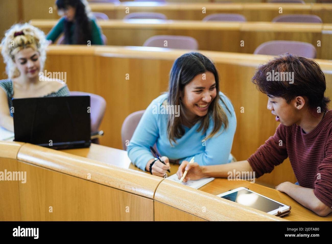 Young multiethnic students working together inside classroom at school university - Focus on asian guy head Stock Photo