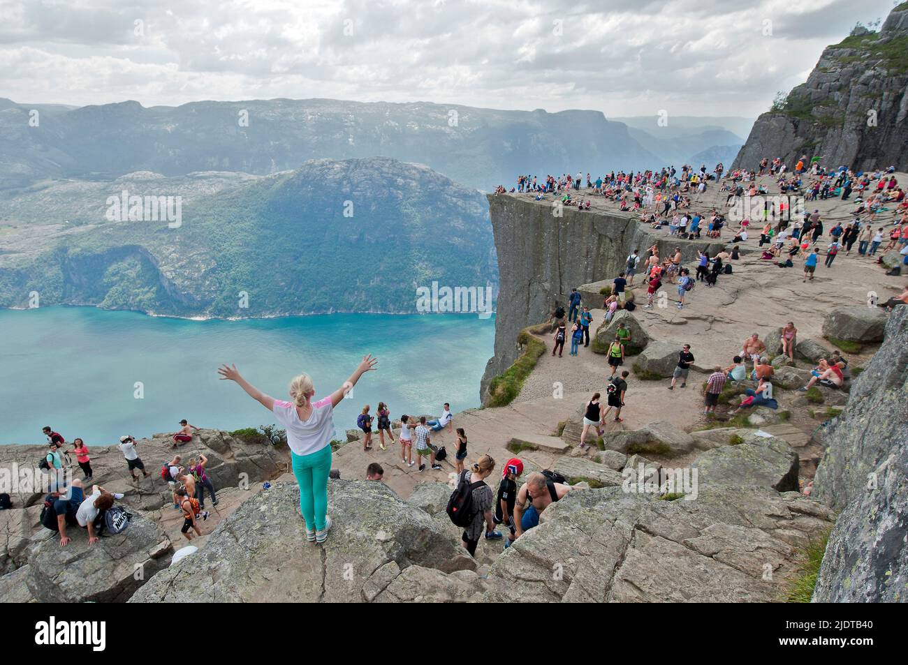 Visitors to the 604 meters high, vertical cliff known as Pulpit Rock (Preikestolen) in Lysefjorden, Forsand county, Rogaland Norway. Stock Photo