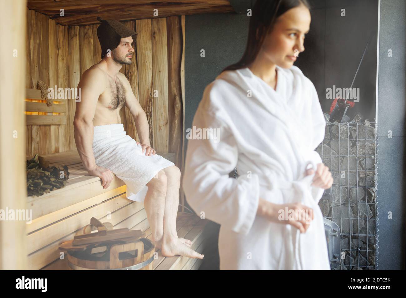 Couple relaxing and sweating in sauna Stock Photo - Alamy