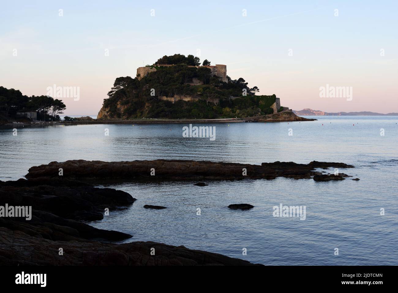 Sunrise or Dusk & Rocky Shoreline in front of the Island and Fort of Bregançon Var Provence France Stock Photo