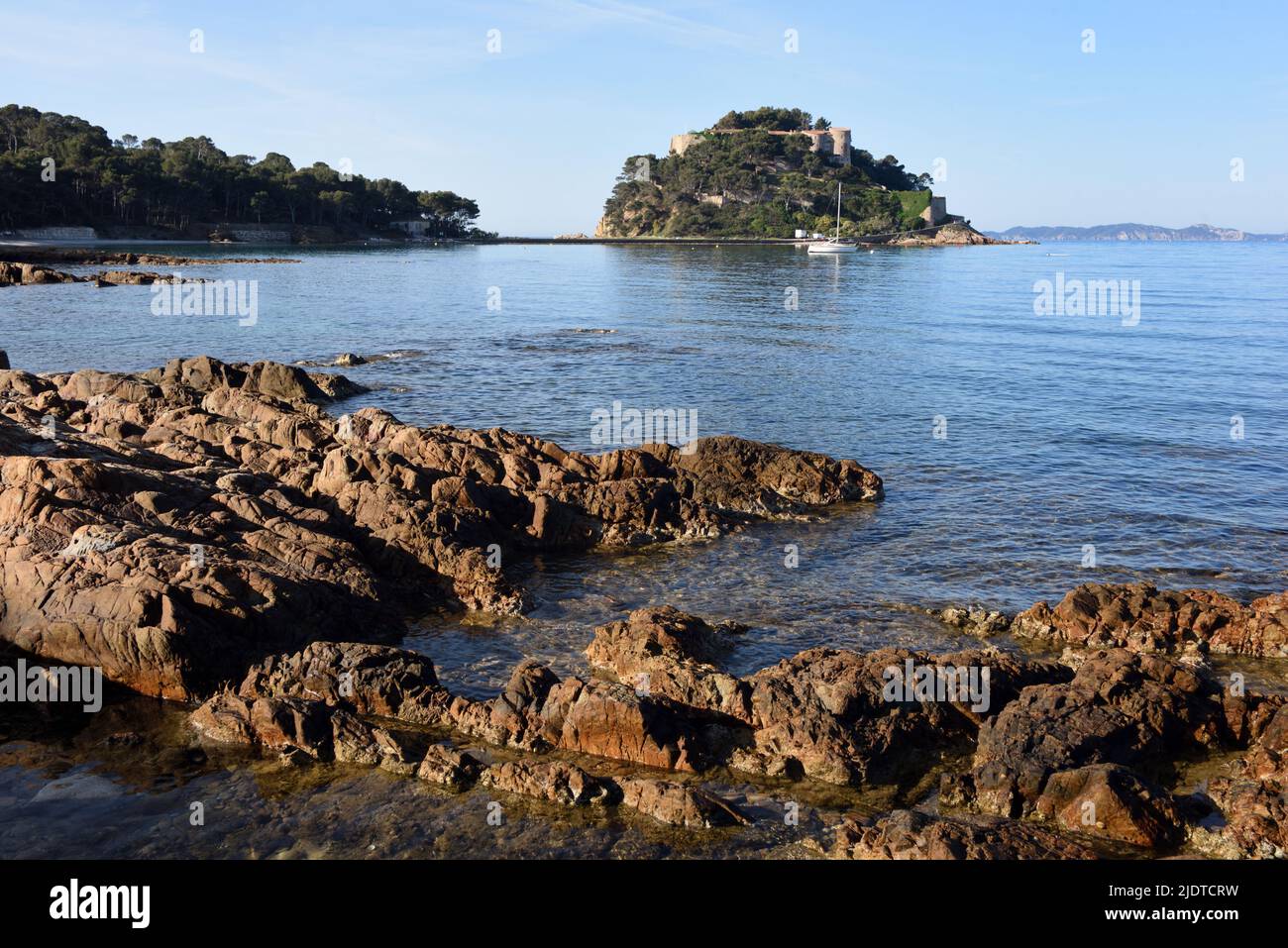 Rocky Coast, Rocks, Shore or Shoreline in front of the Island and Fort of Bregançon Bormes-les-Mimosas Var Provence France Stock Photo