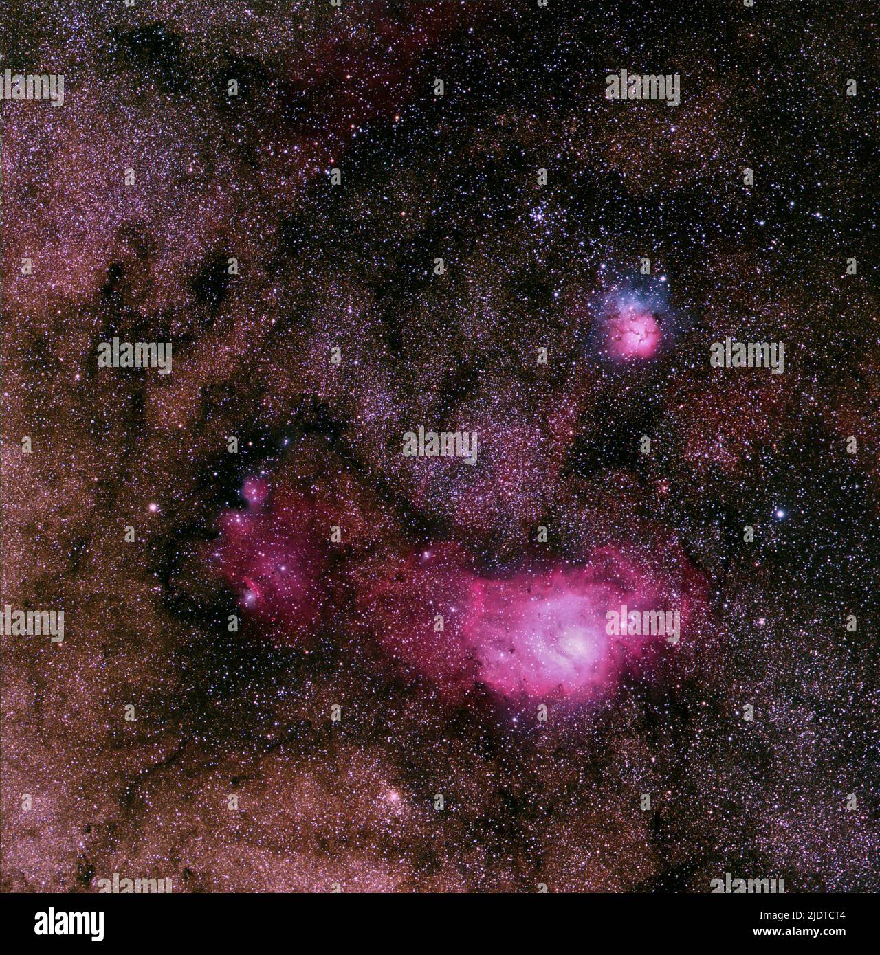 The Lagoon Nebula (Messier 8, lower) and Trifid Nebula (Messier 20) in the constellation Scorpius. Stock Photo
