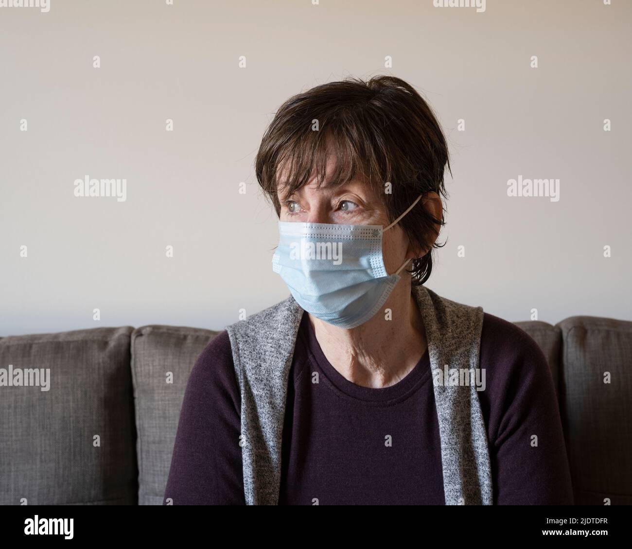 WOMAN WITH CONCERNED LOOK WEARING MASK, SANTA FE, NM, USA Stock Photo