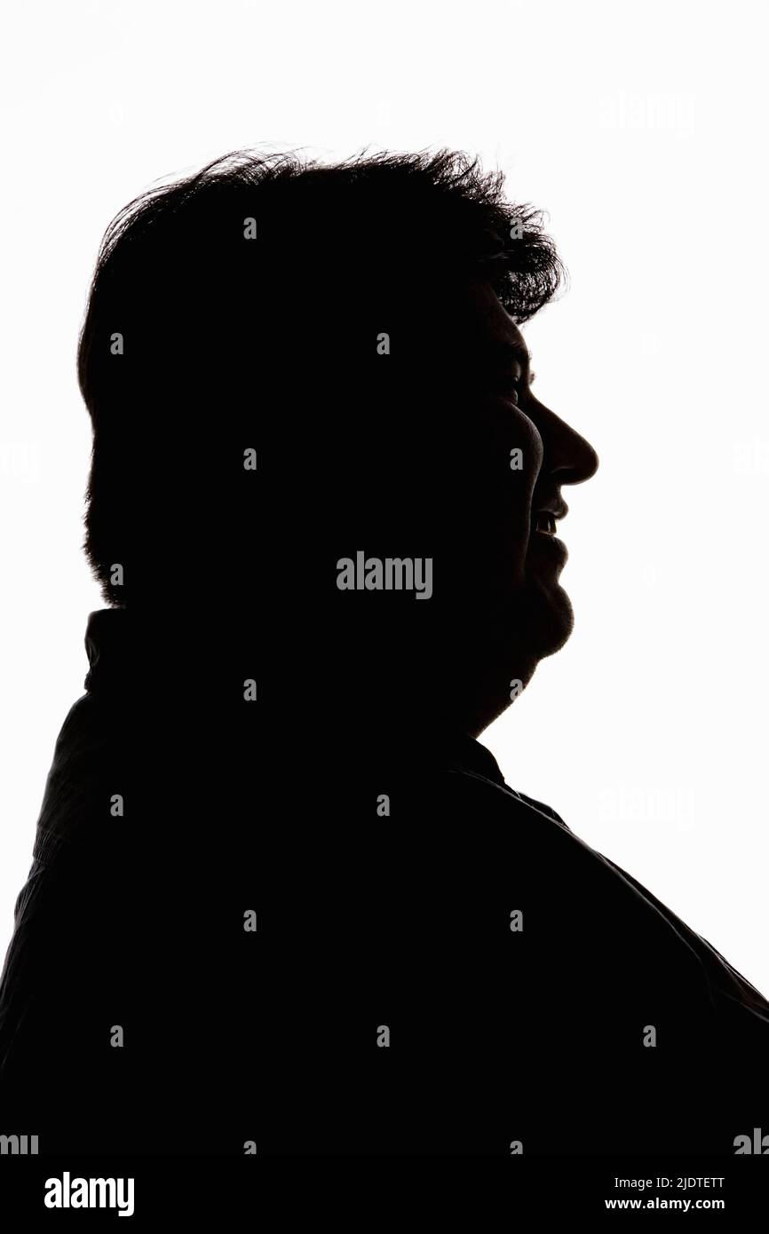 Silhouette of laughing man in profile Stock Photo