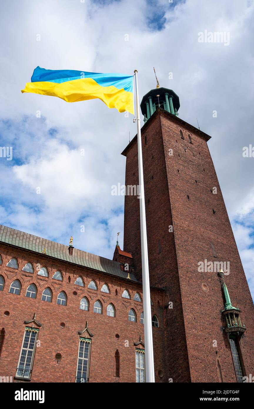 ukrainian flag on the pole in front of the tower of the Stadshuset in Stockholm, Sweden Stock Photo