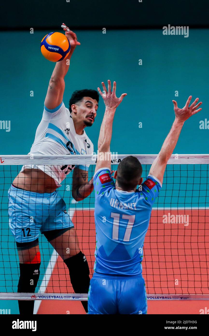 Quezon City. 23rd June, 2022. Argentina's Bruno Lima (L) spikes the ball during the FIVB Volleyball Nations League Men's Pool 3 match between Slovenia and Argentina in Quezon City, the Philippines on June 23, 2022. Credit: Rouelle Umali/Xinhua/Alamy Live News Stock Photo