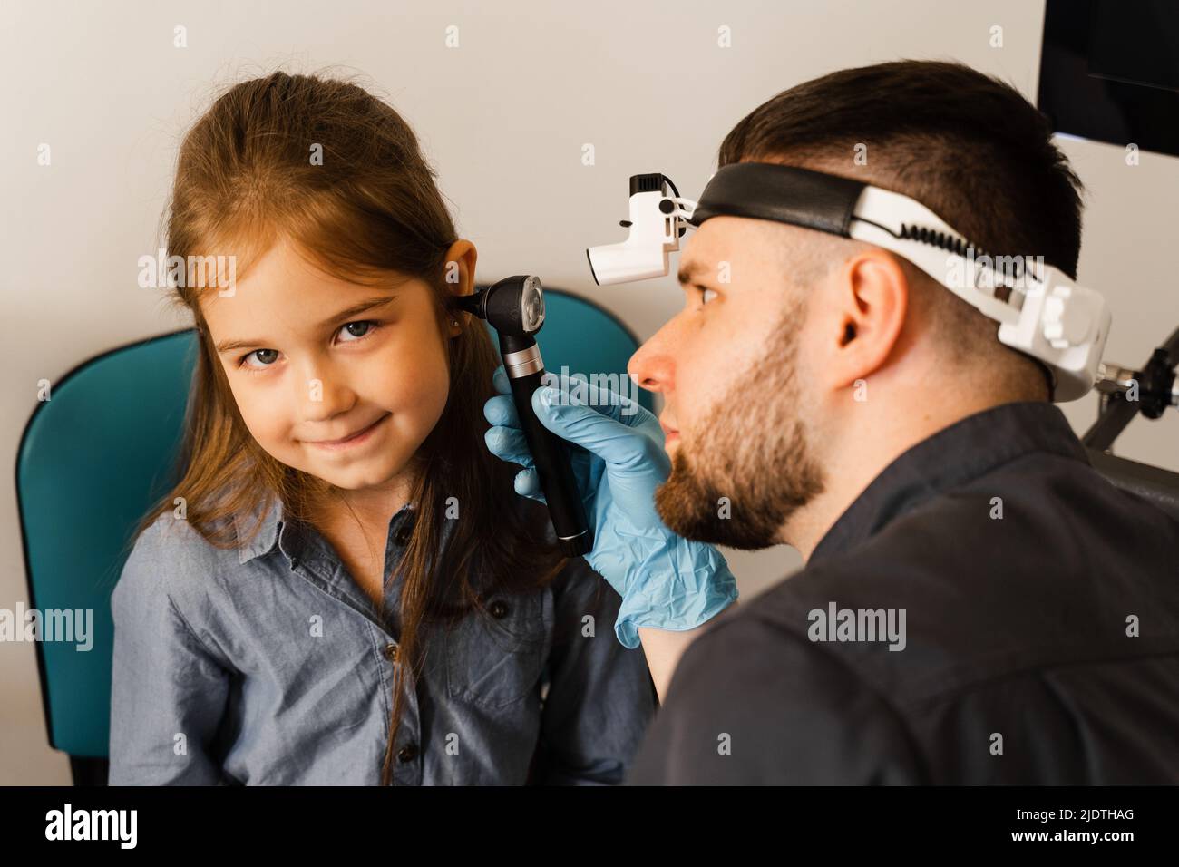 Otoscopy of child ears with otoscope. ENT doctor. Consultation with ...