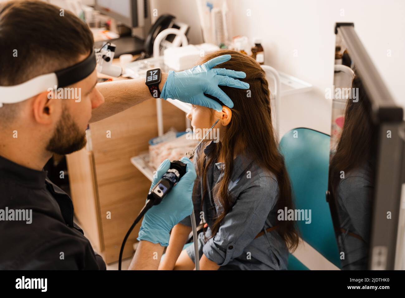 Ears endoscopy of child. Otoscopy procedure with otoscope. ENT doctor