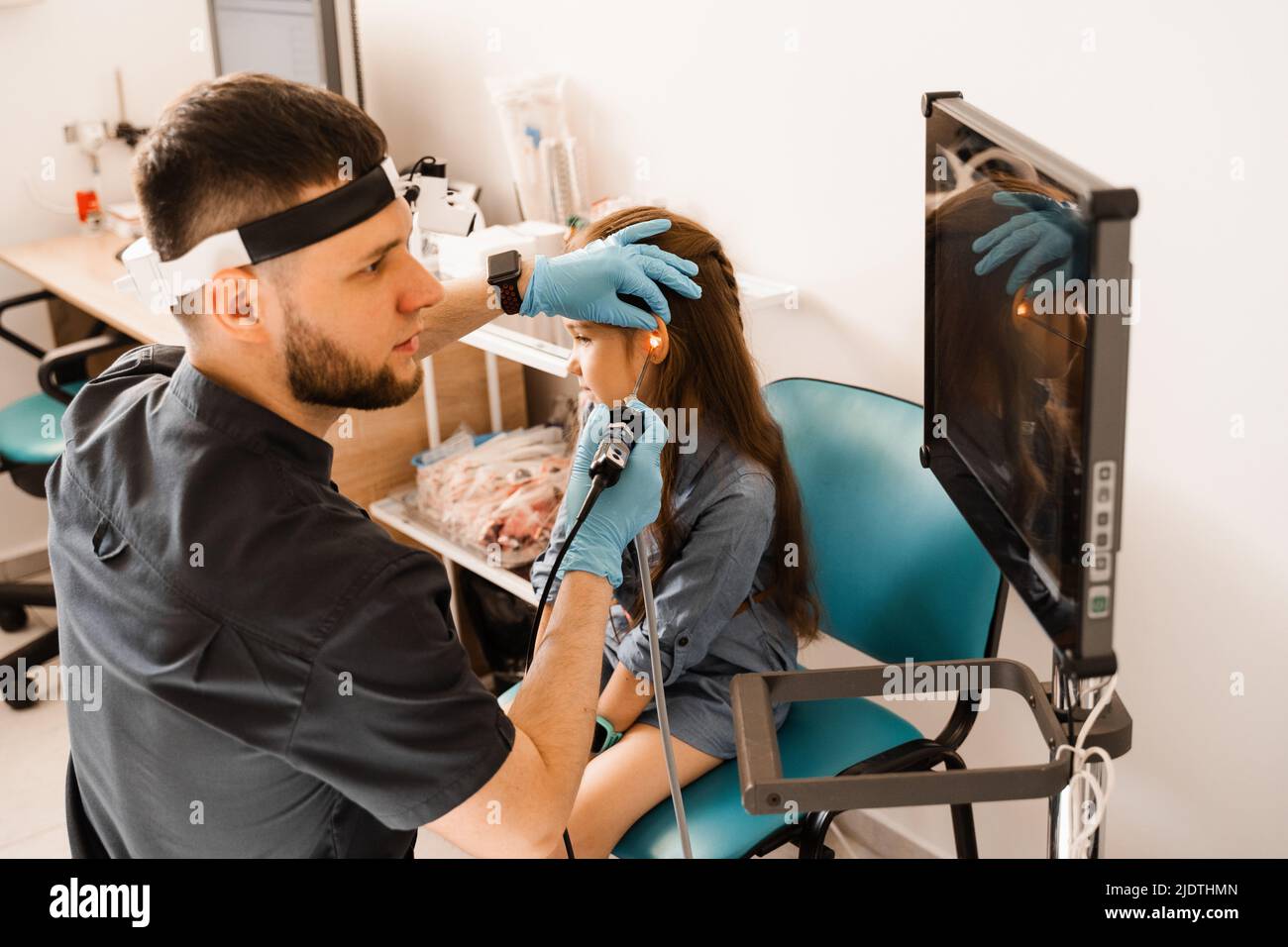 Ears endoscopy of child. Otoscopy procedure with otoscope. ENT doctor