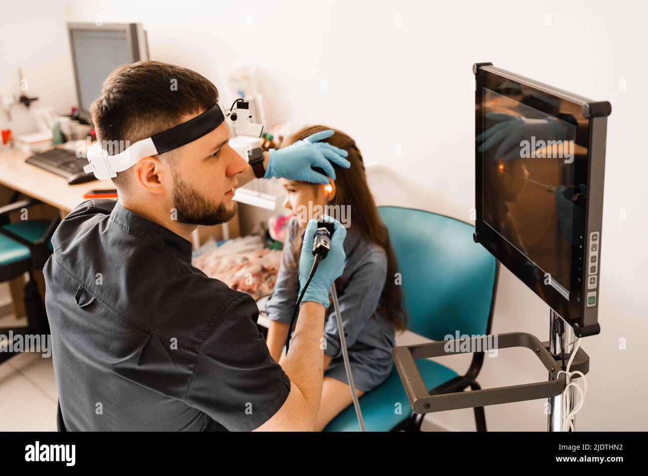 Ears endoscopy of child. Otoscopy procedure with otoscope. ENT doctor