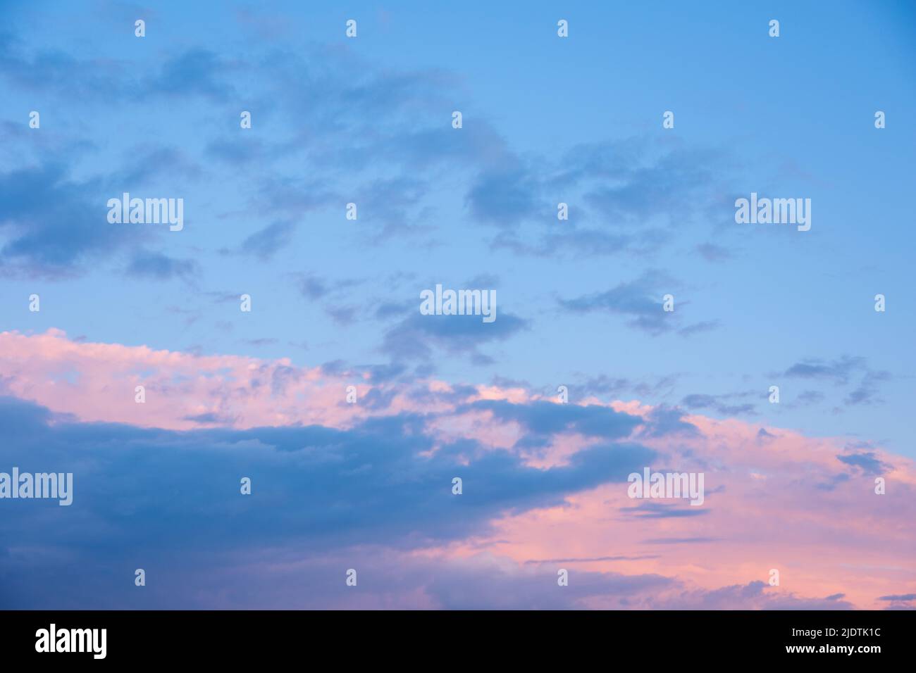 Abstract pink sunset sky and dark blue clouds background with motion ...