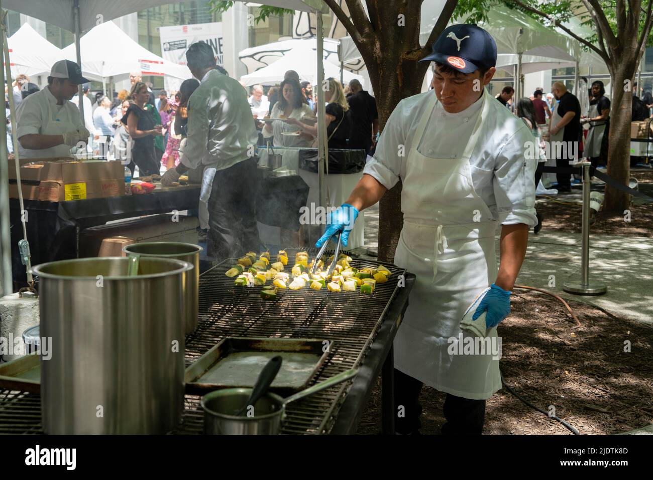 A cook prepared coconut-curry vegetable skewers at Dine Around Downtown, a food festival organized by the Alliance for Downtown New York. Stock Photo