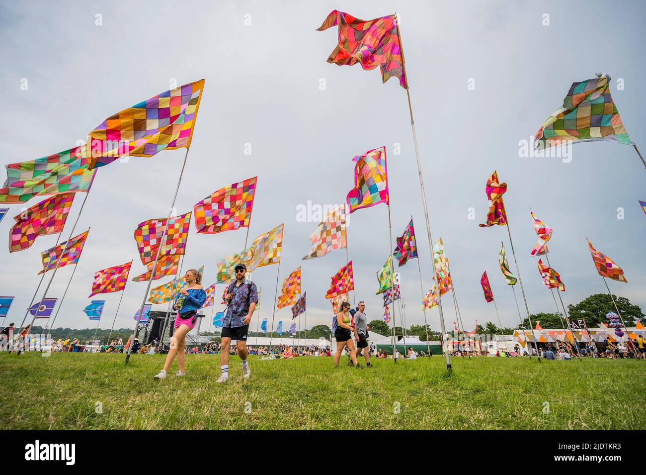 Glastonbury, UK. 23rd June, 2022. Passing through the sea of flags at the Glade - The 50th 2022 Glastonbury Festival, Worthy Farm. Glastonbury, Credit: Guy Bell/Alamy Live News Stock Photo