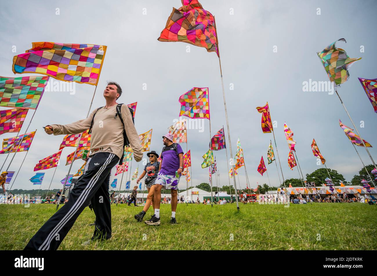 Glastonbury, UK. 23rd June, 2022. Passing through the sea of flags at the Glade - The 50th 2022 Glastonbury Festival, Worthy Farm. Glastonbury, Credit: Guy Bell/Alamy Live News Stock Photo