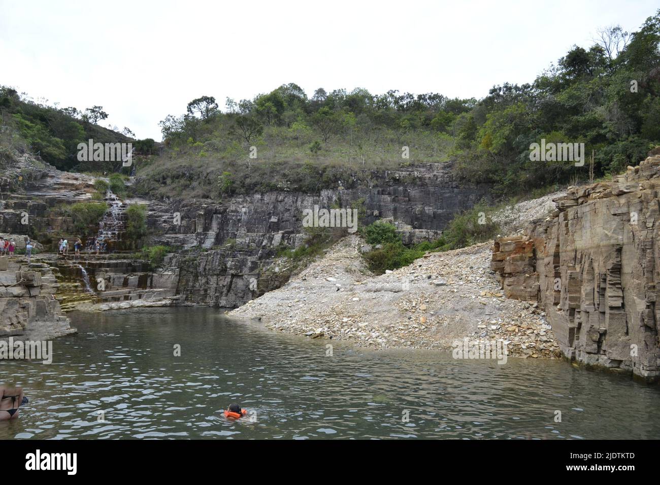 Tourists having fun in the gorge and with natural pool, Brazil, South America, panoramic photo, in the background rocky stones and green nature Stock Photo
