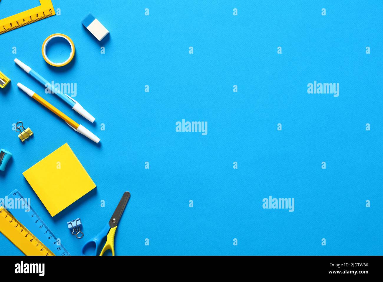 Flat lay blue and yellow office stationery on blue background. Back to ...