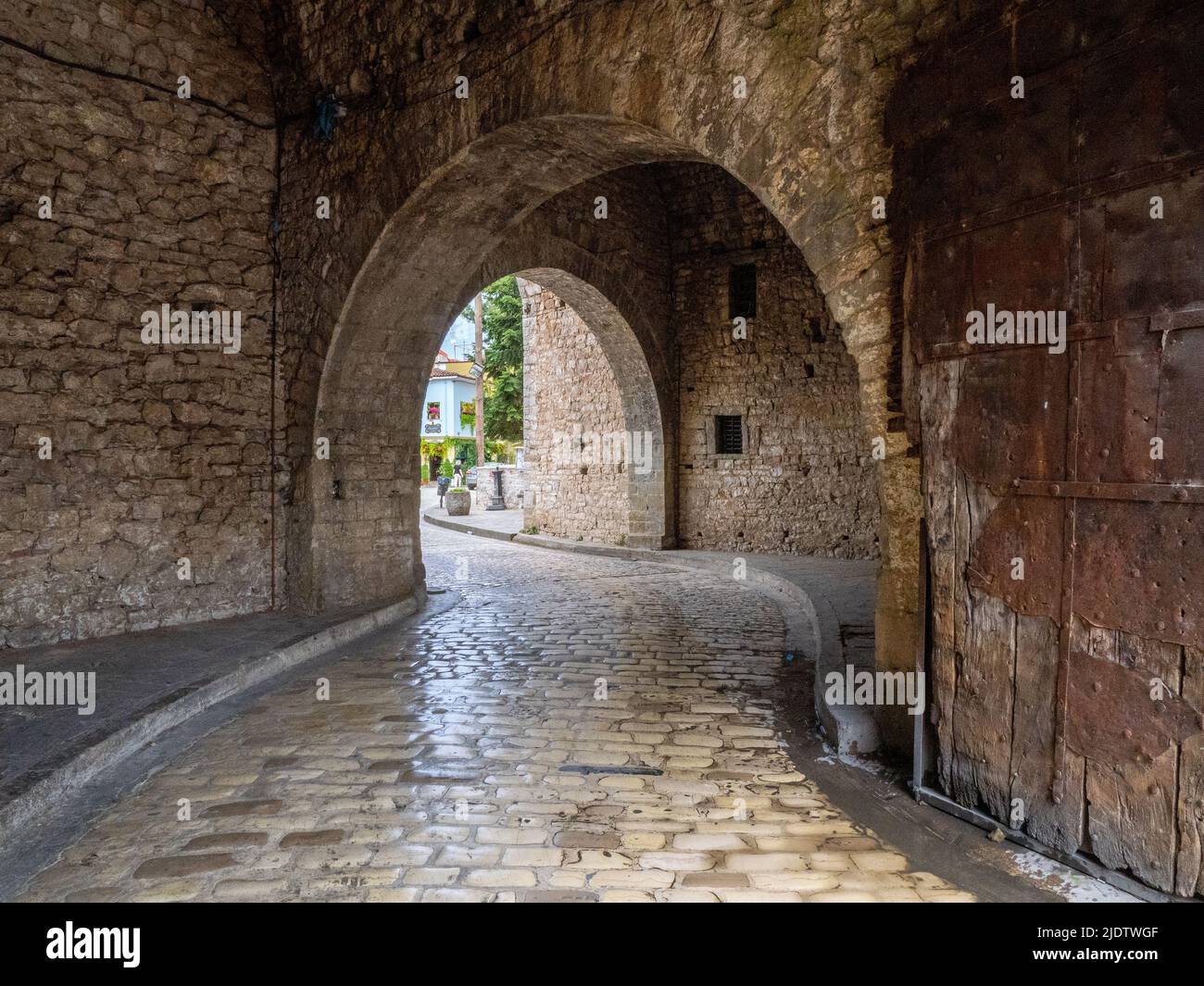 Arched passageway into the ancient walled citadel of Ioannina in Epirus region of northern Greece with preserved remains of original iron-clad door Stock Photo