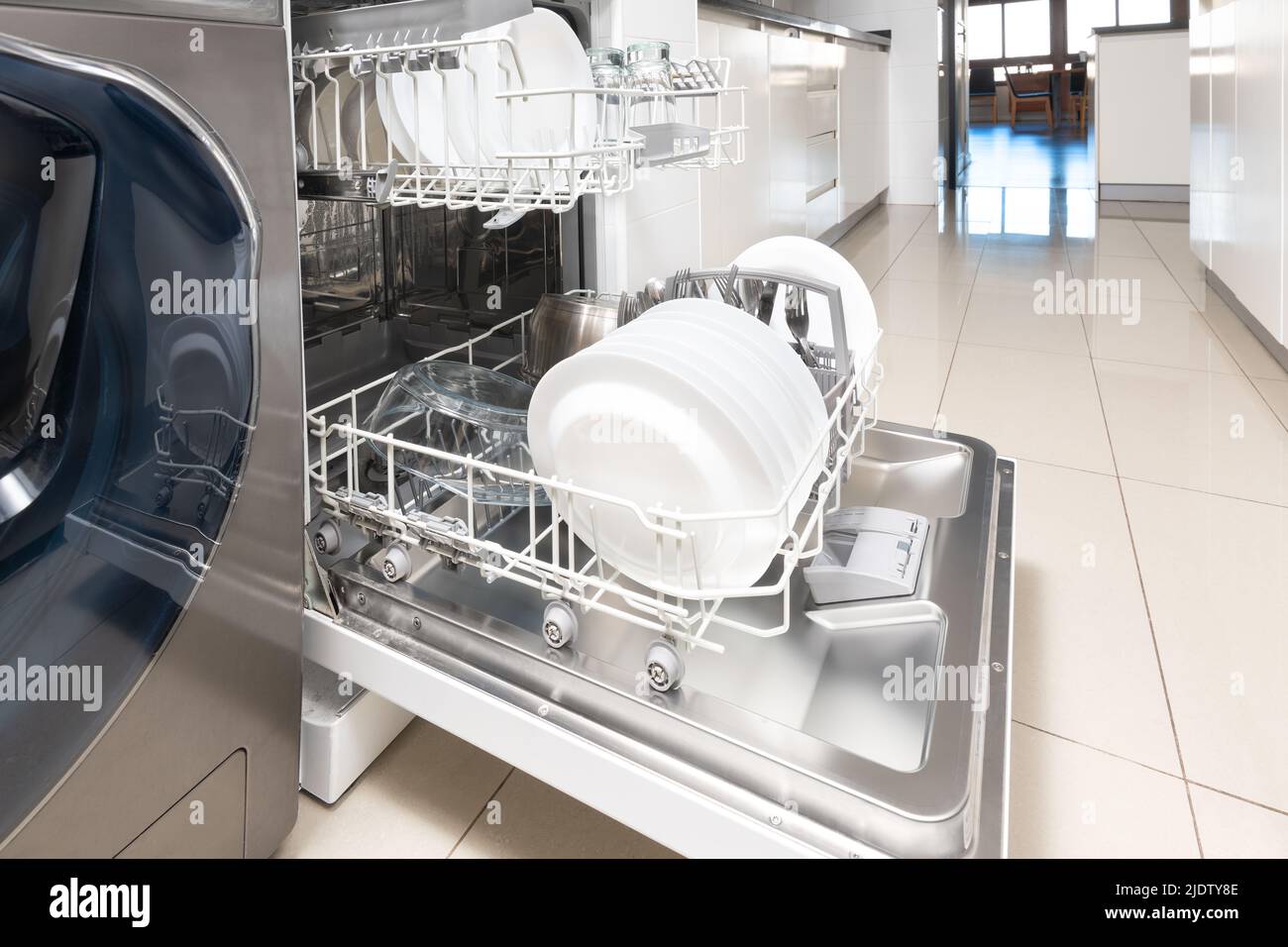 Open dishwasher with clean dishes in a modern kitchen Stock Photo