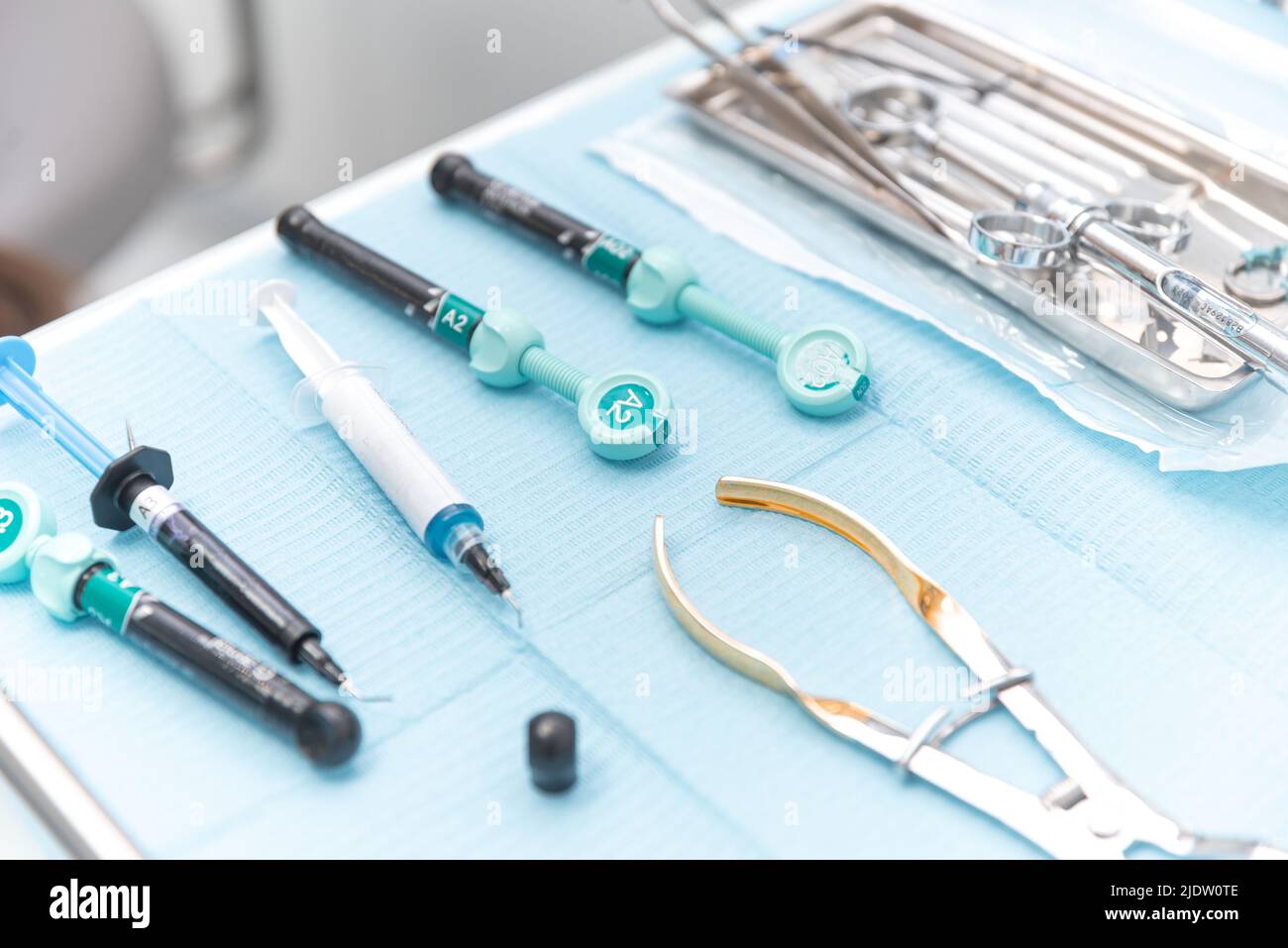 Photo of a set of steril dentistry tools or instruments lying on a light blue table. Stock Photo