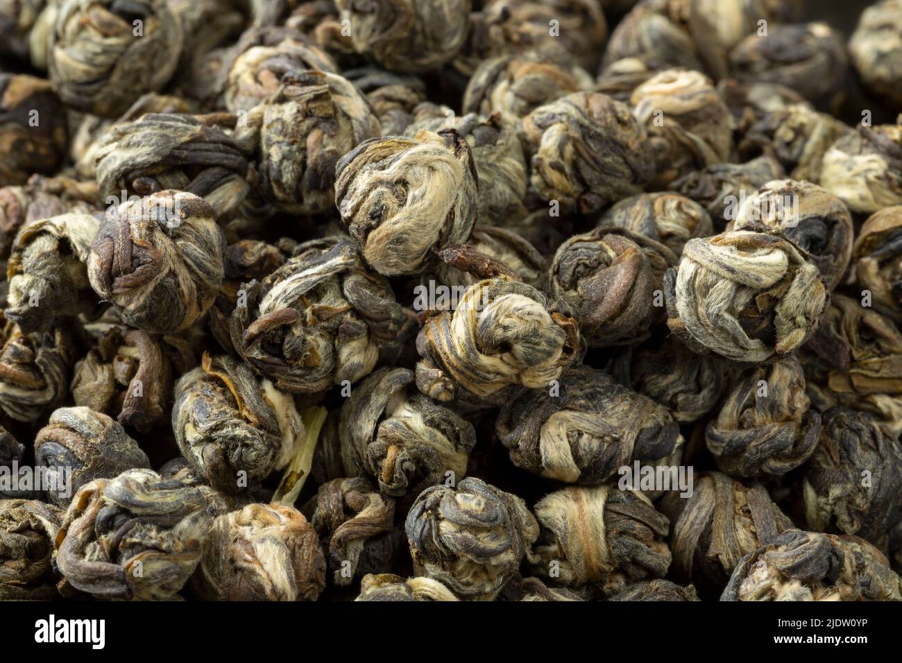 Chinese Jasmine Dragon pearl tea close up full frame as background