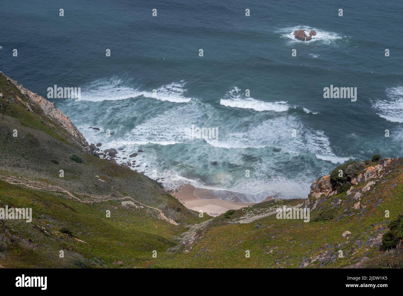 View from above of the descent over cliffs to Praia da Aroeira on the Atlantic coast in Portugal Stock Photo