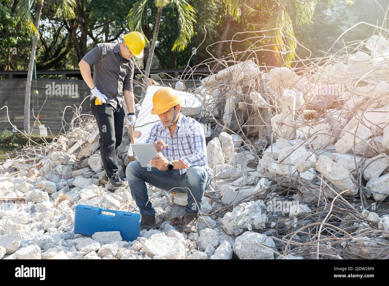 Demolition control supervisor and contractor using tablet to planning on demolish building. Stock Photo