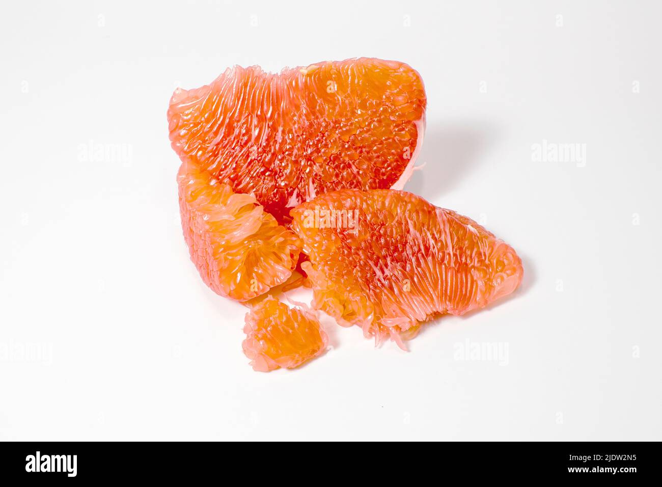 Red pomelo pulp isolated on white background. Natural source of vitamin